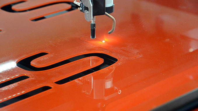 Laser cutting of materials for signage