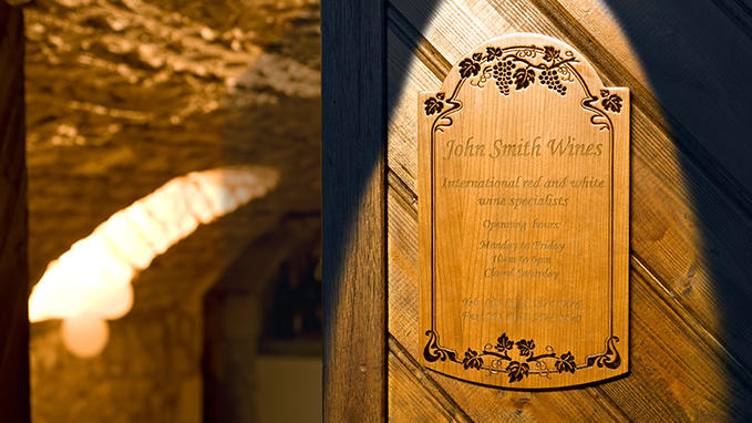 Directional and functional signage: engraved and sculpted wooden plaque for visitor information